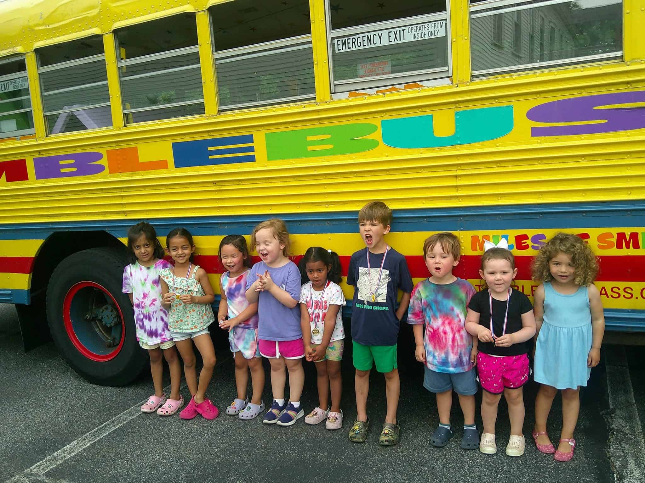 Preschool children in front of a bus outside Boxboro Children Center